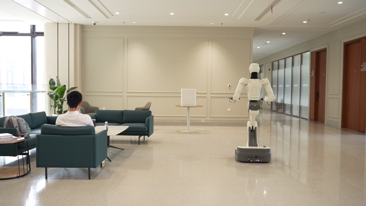 The robot navigates and manipulates in sequence to retrieve and deliver a power bank, frame 1 of 3.