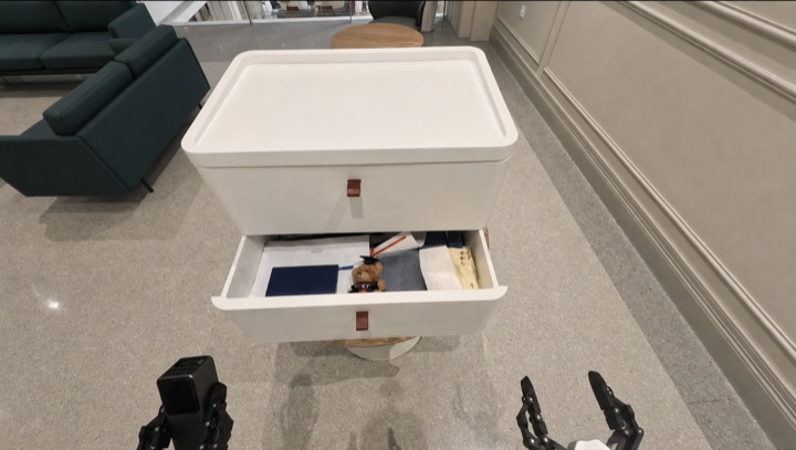 The robot searches cabinet drawers for a power bank absent from the scene graph, frame 3 of 3.